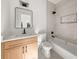 Bathroom featuring a modern vanity with a quartz countertop, a mirror, and a bathtub at 327 Ohm Ave, Avondale Estates, GA 30002