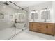 Bright bathroom featuring a soaking tub inside a glass shower and double vanity with framed mirrors at 327 Ohm Ave, Avondale Estates, GA 30002