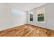 Serene bedroom with ample natural light from large windows and beautiful hardwood flooring at 327 Ohm Ave, Avondale Estates, GA 30002