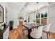 Bright dining room boasts modern chandelier, large windows, and stylish table setting at 327 Ohm Ave, Avondale Estates, GA 30002