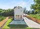 Aerial view of a two-story modern farmhouse with a fenced yard and driveway at 327 Ohm Ave, Avondale Estates, GA 30002