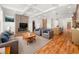 Open living room featuring a fireplace, hardwood floors, and seamless flow to the kitchen at 327 Ohm Ave, Avondale Estates, GA 30002