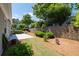 The home has a charming backyard with patio, retaining wall and mature shade trees at 6350 Manningtree Ct, Cumming, GA 30041