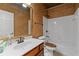 Cozy bathroom with a wood vanity, neutral countertop and a shower and tub combination at 6350 Manningtree Ct, Cumming, GA 30041