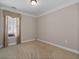 Cozy bedroom with neutral carpet, large window and light, neutral walls at 6350 Manningtree Ct, Cumming, GA 30041