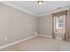 Clean and simple bedroom with large window, neutral carpet and a ceiling light at 6350 Manningtree Ct, Cumming, GA 30041
