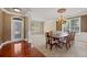 Elegant dining room with hardwood floors, carpet, chandelier, and decorative wall trim at 6350 Manningtree Ct, Cumming, GA 30041