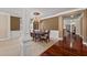 Spacious dining room showcasing hardwood floors, decorative columns, and an elegant chandelier at 6350 Manningtree Ct, Cumming, GA 30041