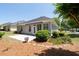 Back exterior of home with well-manicured landscaping, patio, and lots of shade trees at 6350 Manningtree Ct, Cumming, GA 30041