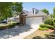 Beautiful home features stone accents, manicured landscaping, and a spacious two-car garage at 6350 Manningtree Ct, Cumming, GA 30041