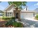 Charming home featuring a stone entryway, two-car garage, and well-maintained landscaping at 6350 Manningtree Ct, Cumming, GA 30041