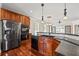 Kitchen with stainless steel appliances, granite counters, breakfast bar, and hardwood floors at 6350 Manningtree Ct, Cumming, GA 30041