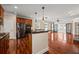 Spacious kitchen boasts cherry cabinets, stainless steel appliances, granite counters, and open concept design at 6350 Manningtree Ct, Cumming, GA 30041