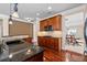 Kitchen with granite counters, cherry cabinets, and eat in bar area with stainless sink at 6350 Manningtree Ct, Cumming, GA 30041