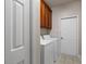 Conveniently located laundry room with a washer, a dryer and some upper cabinets at 6350 Manningtree Ct, Cumming, GA 30041