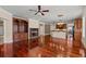 Open living room features hardwood floors, fireplace and views of kitchen at 6350 Manningtree Ct, Cumming, GA 30041