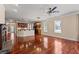 Open floor plan showing hardwood floors, fireplace, kitchen and access to outdoor spaces at 6350 Manningtree Ct, Cumming, GA 30041