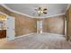 Large main bedroom features neutral carpet, tray ceilings, and an ensuite bathroom at 6350 Manningtree Ct, Cumming, GA 30041