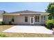 Home's back exterior and patio area with a retractable awning for shaded comfort at 6350 Manningtree Ct, Cumming, GA 30041