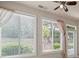 Sunroom with multiple windows offering abundant natural light and exterior views at 6350 Manningtree Ct, Cumming, GA 30041