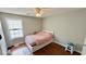 Bright bedroom featuring hardwood floors, a large window, and neutral color scheme at 1972 Brittania Cir, Woodstock, GA 30188