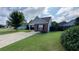 Charming single-story home featuring manicured lawn, gray siding and a brick accent wall at 1972 Brittania Cir, Woodstock, GA 30188