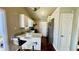 Well-lit kitchen with granite countertops, white cabinets, stainless steel refrigerator, and barstool seating at 1972 Brittania Cir, Woodstock, GA 30188