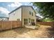 Spacious backyard with a wooden fence, lawn, and patio area at 2521 Livingston Ct, Loganville, GA 30052
