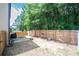 Private backyard featuring a wood fence, patio, and views of mature trees and lush landscaping at 2521 Livingston Ct, Loganville, GA 30052