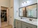 Bright bathroom with a double sink vanity, granite counters, and walk-in closet at 2521 Livingston Ct, Loganville, GA 30052