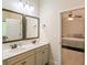 Bathroom featuring double sink vanity with marble counters and an open view to the bedroom at 2521 Livingston Ct, Loganville, GA 30052