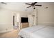 Well-lit bedroom featuring carpet, a ceiling fan, and convenient access to the en-suite bathroom at 2521 Livingston Ct, Loganville, GA 30052