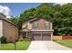 Charming two-story home featuring a brick facade, two-car garage, and a well-maintained front yard at 2521 Livingston Ct, Loganville, GA 30052