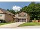 Inviting two-story home with brick accents, a two-car garage, and a beautifully landscaped yard at 2521 Livingston Ct, Loganville, GA 30052