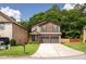 Attractive two-story home featuring brick detailing, a two-car garage, and a well-manicured lawn at 2521 Livingston Ct, Loganville, GA 30052