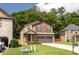 Beautiful two-story home boasting a brick front, two-car garage, and lush greenery at 2521 Livingston Ct, Loganville, GA 30052
