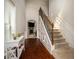 Elegant foyer with hardwood floors, a staircase with wrought iron railings, and decorative wainscoting at 2521 Livingston Ct, Loganville, GA 30052