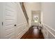 Bright entryway with hardwood floors, white wainscoting, and a staircase leading upstairs at 2521 Livingston Ct, Loganville, GA 30052