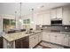 Modern kitchen featuring stainless steel appliances, granite countertops, and ample cabinet space at 2521 Livingston Ct, Loganville, GA 30052