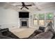 Comfortable living room with a stone fireplace, a ceiling fan, and plush seating at 2521 Livingston Ct, Loganville, GA 30052