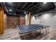 Basement featuring brick accent wall, wooden support beams, and exposed ceiling at 2795 Bentwood Dr, Marietta, GA 30062