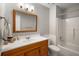 Bathroom with wood vanity, mirror, shower-tub, and wainscoting at 2795 Bentwood Dr, Marietta, GA 30062