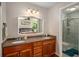 Bathroom featuring double vanity with granite countertops, and a marble tiled shower with glass doors at 2795 Bentwood Dr, Marietta, GA 30062