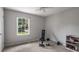Simple bedroom with neutral carpet, natural light, and workout equipment at 2795 Bentwood Dr, Marietta, GA 30062