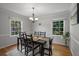 Formal dining room with elegant lighting, hardwood floors, and serene window views at 2795 Bentwood Dr, Marietta, GA 30062
