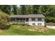 Charming split-level home featuring a landscaped front yard and a cozy front porch at 2795 Bentwood Dr, Marietta, GA 30062