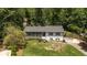 Split-level home nestled on a tree-lined lot, featuring a charming front porch and landscaping at 2795 Bentwood Dr, Marietta, GA 30062