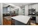 Open concept kitchen with white cabinetry and island flows into a living area at 2795 Bentwood Dr, Marietta, GA 30062