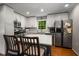 Bright kitchen features white cabinets, stainless steel appliances, and island with seating at 2795 Bentwood Dr, Marietta, GA 30062
