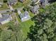 Aerial view captures a home with a green lawn and treed surroundings within a neighborhood at 5706 Brookstone Nw Walk, Acworth, GA 30101